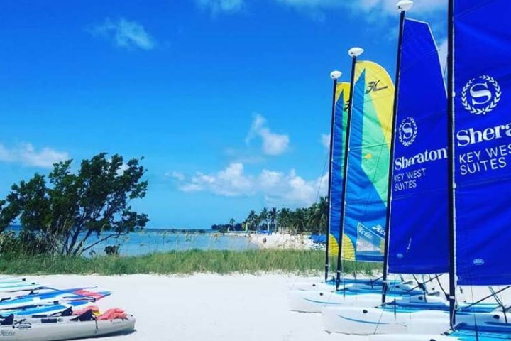 a blue and white boat sitting next to a body of water