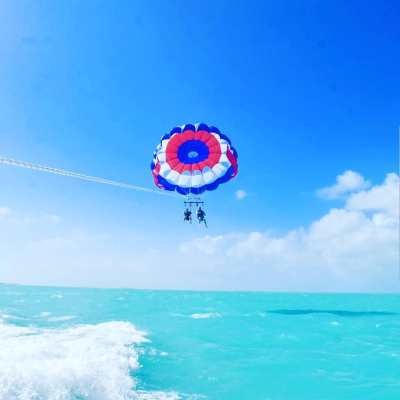 a man flying through the air while riding a wave in the ocean