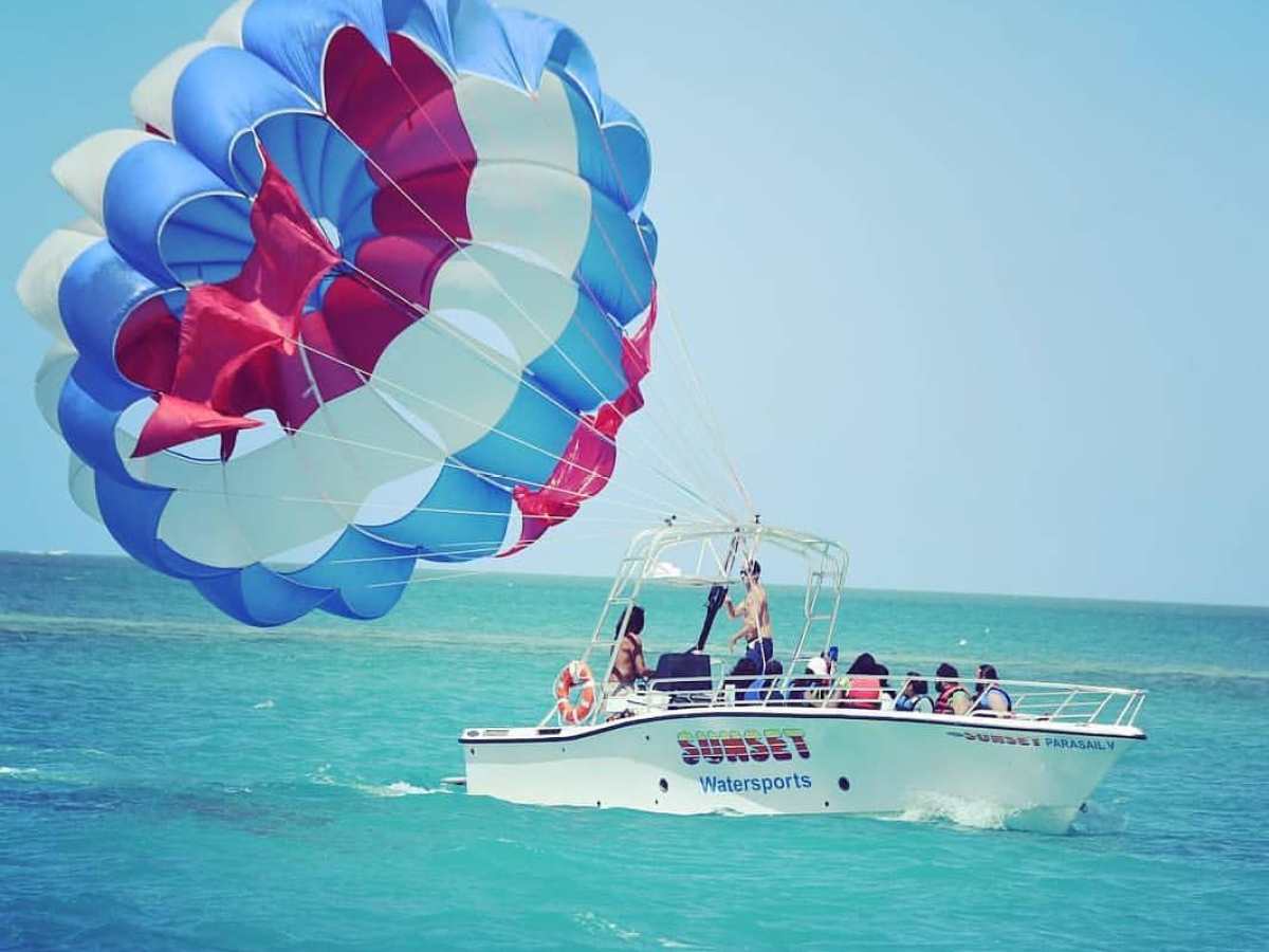 a blue and white kite in a boat on the water
