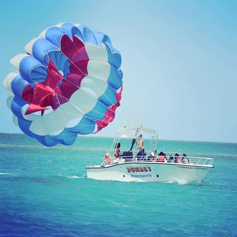 a blue and white kite in a boat on the water