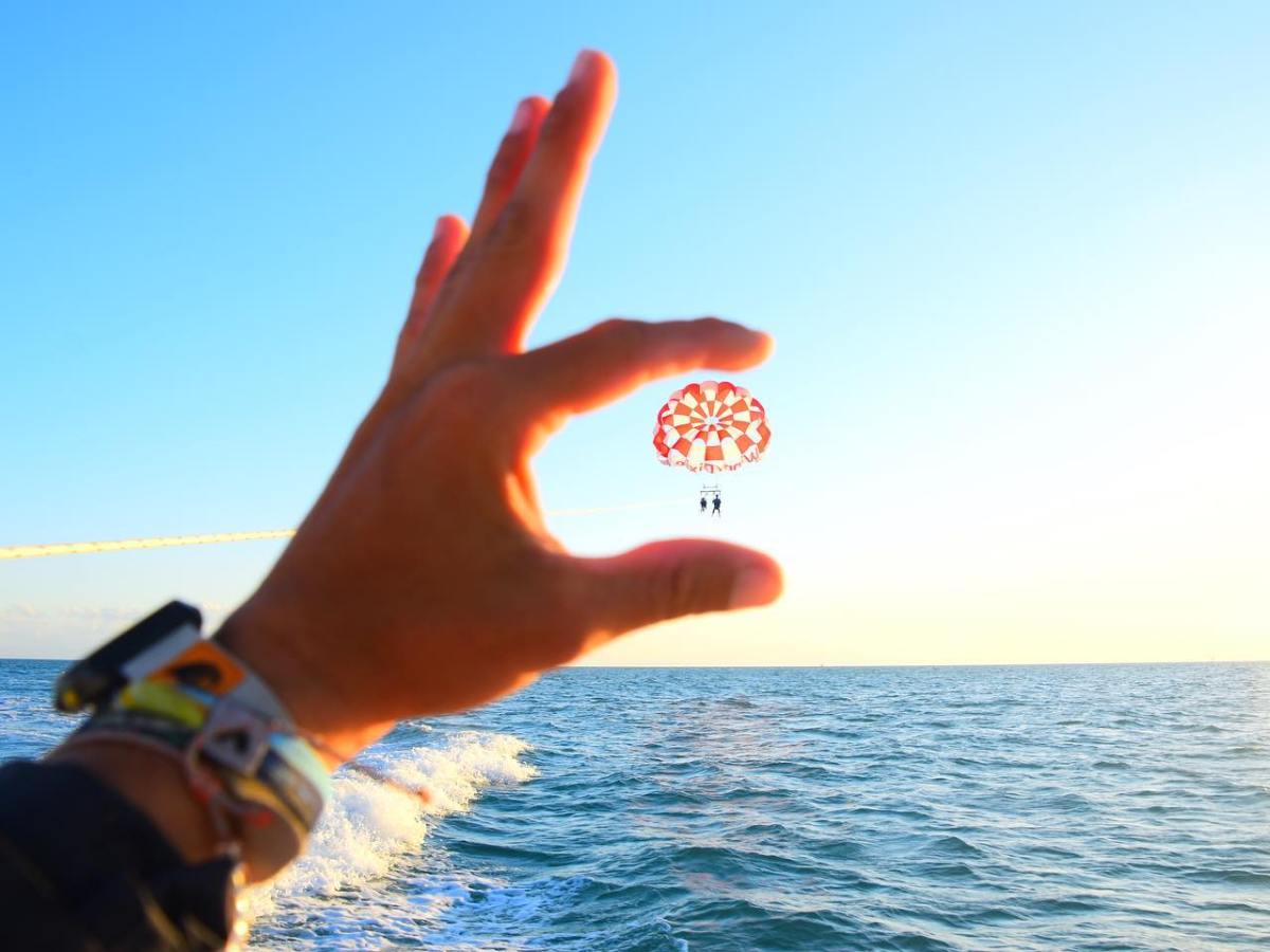 a man holding a frisbee in a body of water