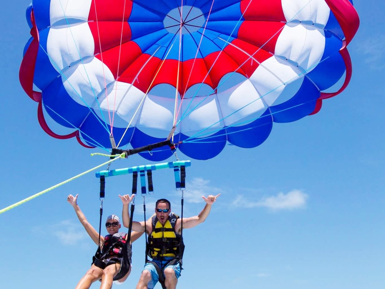 a person flying through the air on a parachute