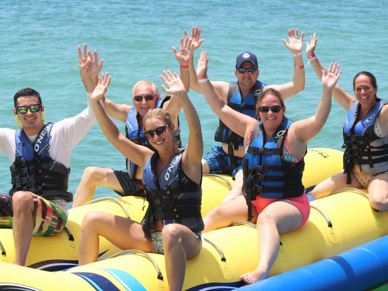 a group of people sitting next to a body of water