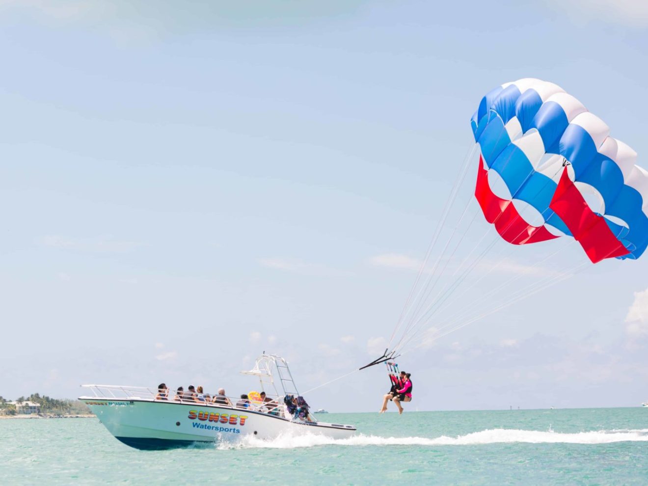 a man flying a kite in a boat on a body of water